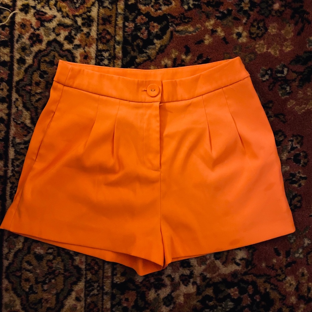 Size small high waisted neon orange shorts.